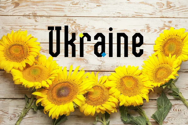 Fresh Sunflowers Word Ukraine White Wooden Background — стокове фото