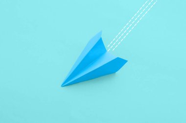 Paper plane on light blue background
