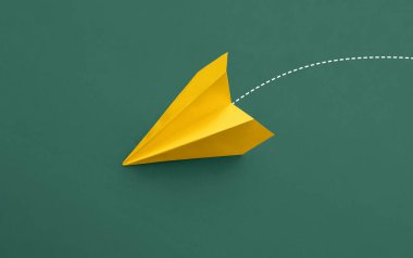 Paper plane on green background