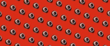 Tasty scary candies for Halloween on red background