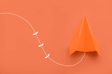 Paper plane on orange background