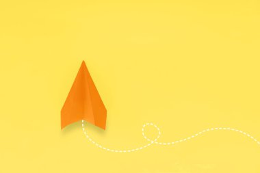 Paper plane on yellow background