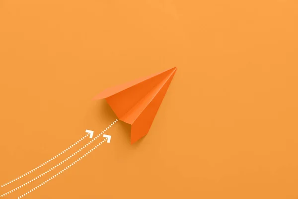 Paper plane on orange background
