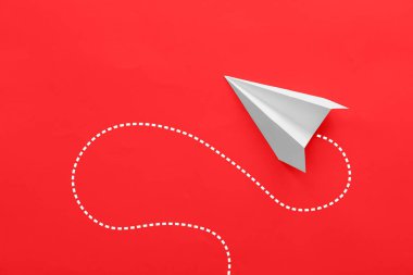 Paper plane on red background
