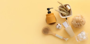 Set of bath supplies on beige background with space for text