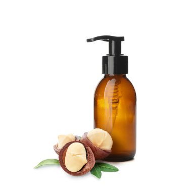 Bottle of natural cosmetics with macadamia extract on white background