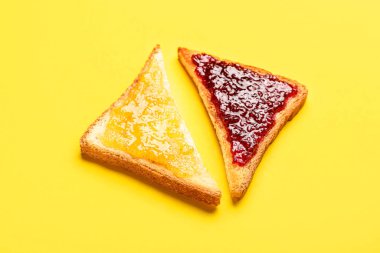 Toasts with sweet jam on yellow background
