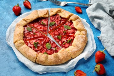 Delicious strawberry galette on color background