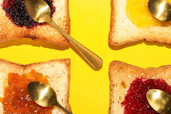 Tasty Toasts Jam Spoons Yellow Background Closeup — Stock Photo, Image