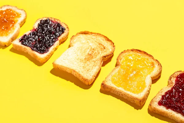 Pieces Toasted Bread Different Jams Yellow Background Closeup — Stock Photo, Image