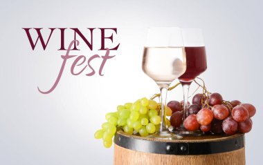 Barrel and glasses of different wine on light background