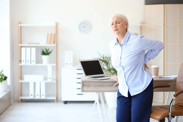 Mature Businesswoman Suffering Back Pain Office — Foto de Stock