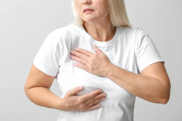 Mature Woman Suffering Breast Pain Light Background Closeup — Stock Photo, Image