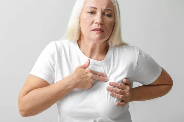 Mature Woman Suffering Breast Pain Light Background — Stock Photo, Image
