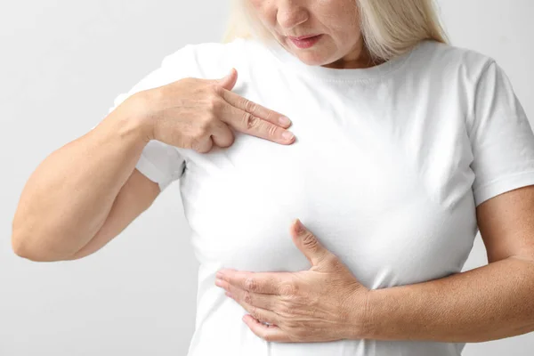 Mature Woman Suffering Breast Pain Light Background Closeup —  Fotos de Stock