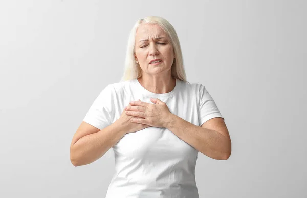 Mature Woman Suffering Breast Pain Light Background — Stock Fotó
