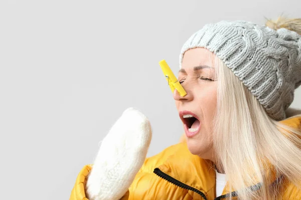 Ill Mature Woman Clothespin Light Background Stuffy Nose Concept — Fotografia de Stock
