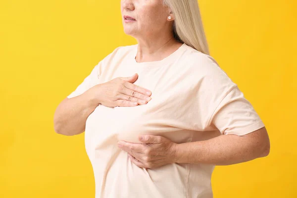 Mature Woman Suffering Breast Pain Yellow Background — Stock Photo, Image