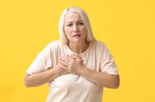 Mature Woman Suffering Breast Pain Yellow Background — Stock Fotó