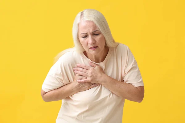 Mature Woman Suffering Breast Pain Yellow Background — Stok fotoğraf