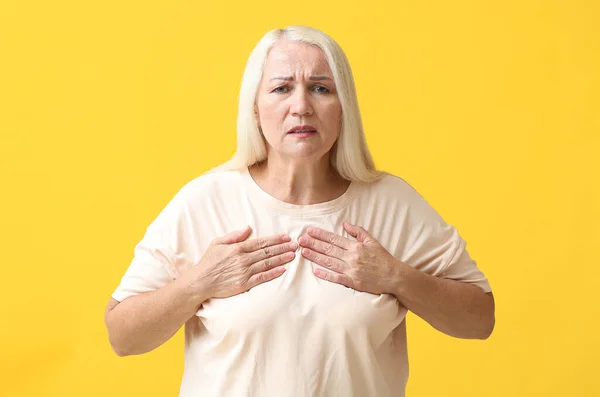 Mature Woman Suffering Breast Pain Yellow Background — Stock Photo, Image