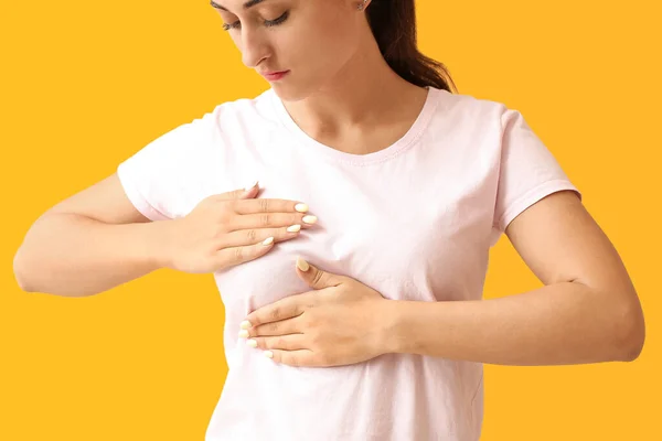 Young Woman Suffering Breast Pain Yellow Background Closeup — Stock Photo, Image