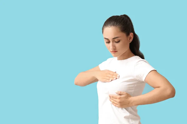 Young Woman Suffering Breast Pain Blue Background — Stock Fotó