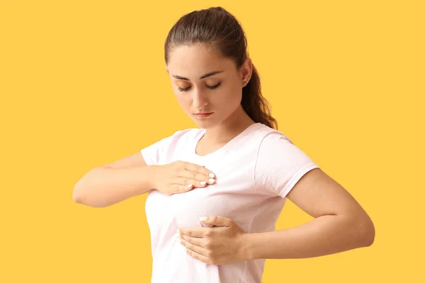 Young Woman Suffering Breast Pain Yellow Background — Stock Fotó