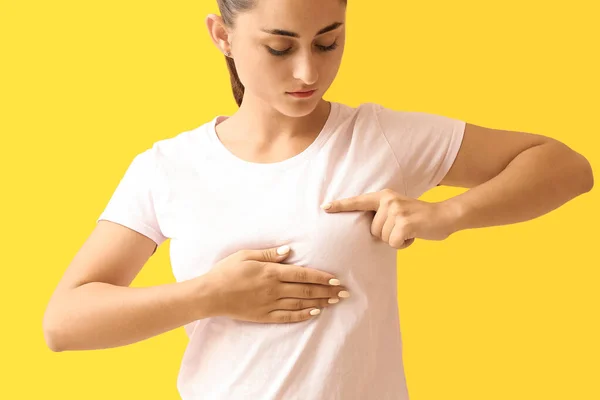 Young Woman Suffering Breast Pain Yellow Background — Stock Photo, Image