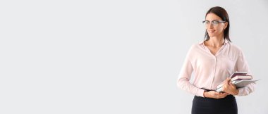 Female teacher on light background with space for text