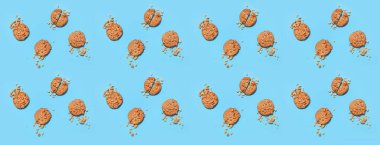 Tasty peanut cookies on blue background, top view