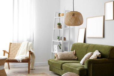 Interior of cozy living room with green sofa and armchair