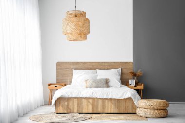 Interior of cozy bedroom with rattan poufs