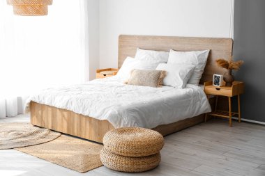 Interior of cozy bedroom with rattan poufs