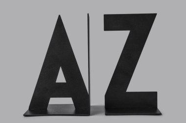 Black bookend in shape of letters on grey background