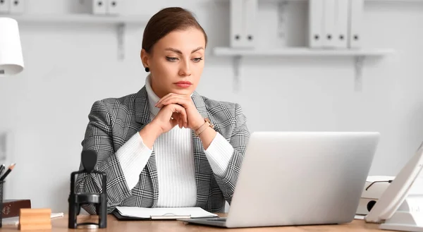 Female notary public working in office