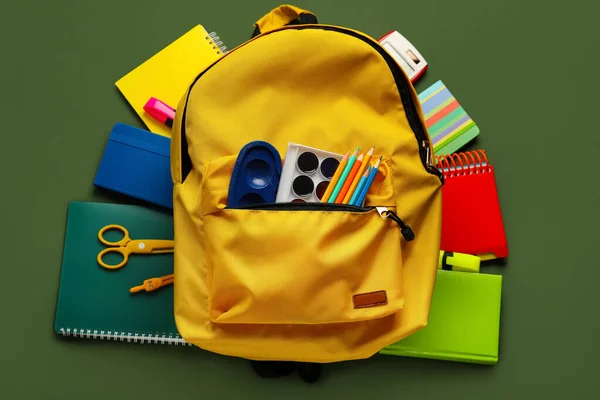 Yellow Backpack School Stationery Green Background — Zdjęcie stockowe