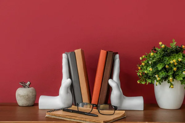 Stylish Holder Books Eyeglasses Flowerpot Table Red Wall — 스톡 사진