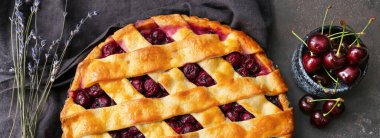 Delicious cherry pie on dark grey table, top view