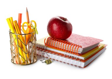 Pen cup with school stationery, notebooks and apple on white background