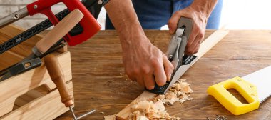 Male carpenter in his workshop, closeup