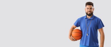 Portrait of male PE teacher on light background with space for text