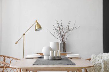 Simple table setting with candles in kitchen