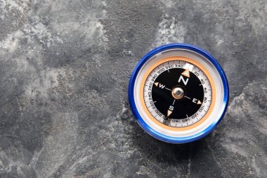 Tourist's compass on grunge background