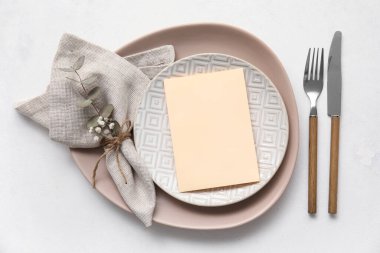 Simple table setting with floral decor on white background