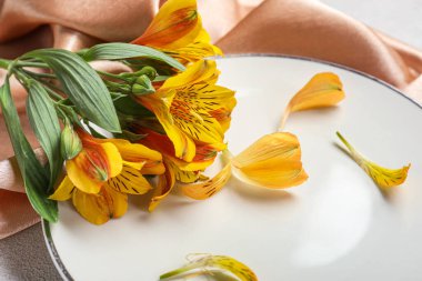 Plate with beautiful alstroemeria flowers, closeup