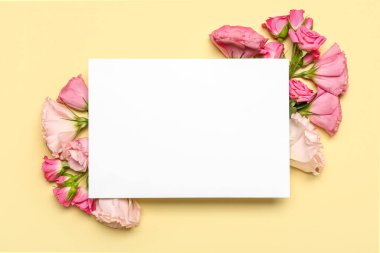 Blank paper sheet with beautiful flowers on beige background