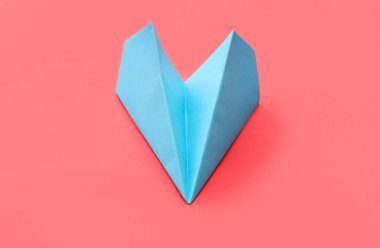 Blue paper plane on red background