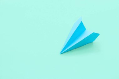 Blue paper plane on color background