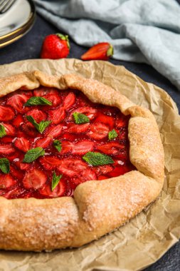 Delicious strawberry galette on table, closeup